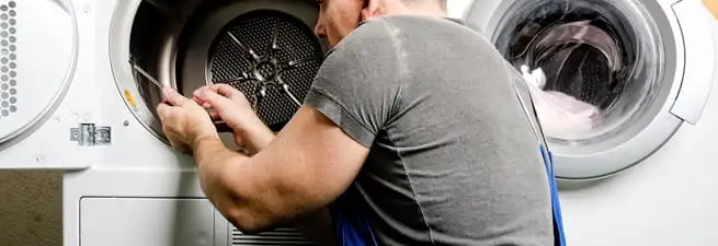 Dryer repair technician fixing a clothes dryer drum in Cincinnati, OH