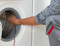 Dryer repair technician diagnosing and servicing a clothes dryer in Cincinnati, OH