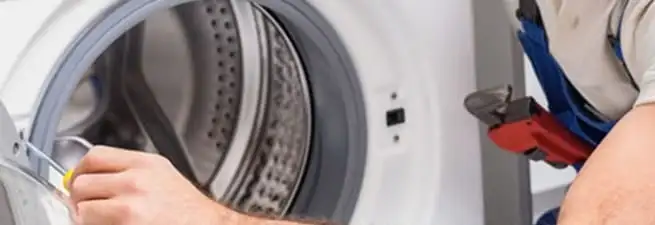 Appliance technician repairing a clothes dryer drum and internal parts in Cincinnati, OH