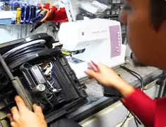 Vacuum repair technician servicing internal components on a workbench in Cincinnati, OH