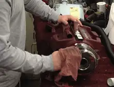 Vacuum repair technician cleaning and servicing a vacuum motor in Cincinnati, OH