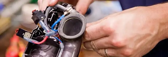 Vacuum repair technician reconnecting wiring and components in Cincinnati, OH